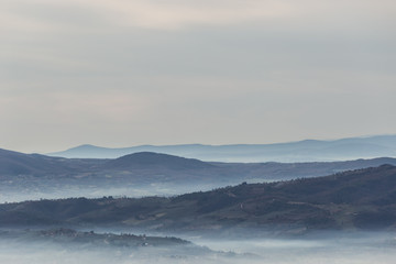 Sea of fog and mist between layers of mountains and hills