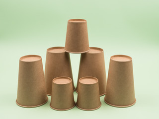 Group of paper cups on a green background.