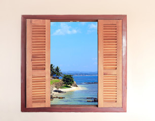 View of ocean through window with wooden shutters © frenta