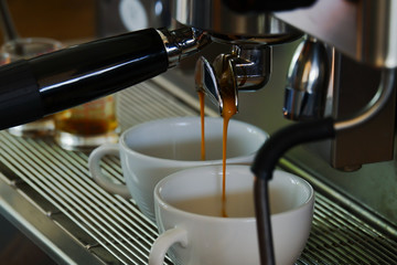 Professional coffee machine making coffee in a cafe . Coffee flows out of the automatic coffee machine.