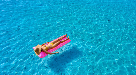 Woman relaxing on inflatable mat float