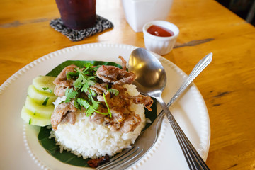 Rice topped with stir-fried pork and basil 