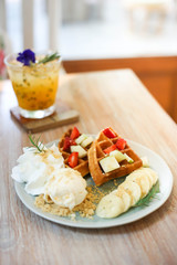 Waffle of fresh berries  strawberry, blueberry, bananas and chocolate topping,Sweet dessert cafe