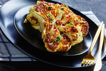 Healthy roasted cauliflower steaks on a plate