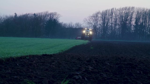 tractor plowing in the fields prepering for farming in the sunset sunrice