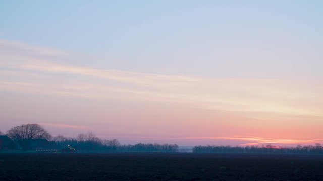 tractor plowing in the fields prepering for farming in the sunset sunrice