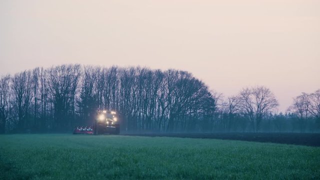 tractor plowing in the fields prepering for farming in the sunset sunrice