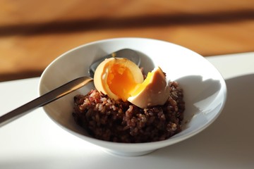Soft-boiled egg on top of whole grain rice