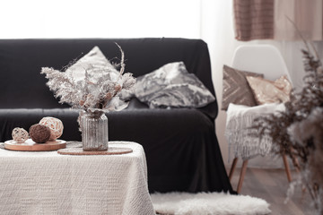 Home cozy still life with a black sofa and decor in the living room.