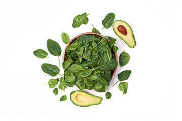 Fresh avocado with spinach in a wooden bowl isolated on white background top view photo
