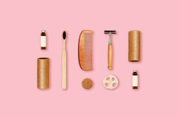 Ecological accessories for body care located on pink background.