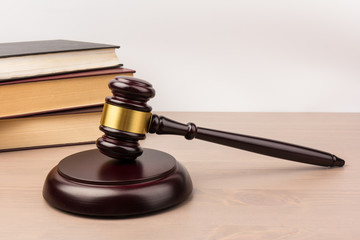 Wooden judges gavel on wooden table, close up. Space for text