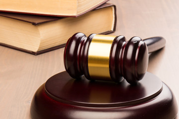 Wooden judges gavel on wooden table, close up. Space for text