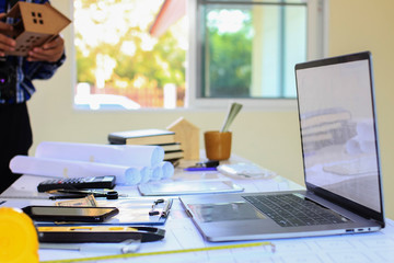 Desk of Architectural working project in construction site,With drawing equipment concept.