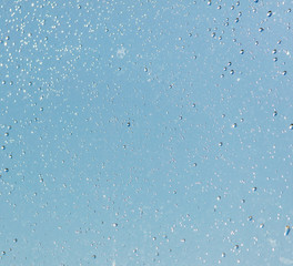 Drops of water on a blue glass window