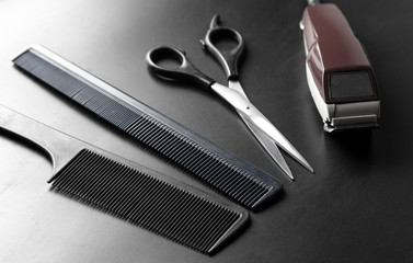 Hair cutting tools on a black background