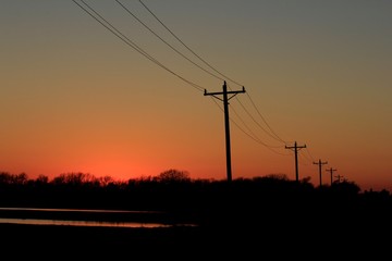 Fototapeta na wymiar Kansas Sunset with Power Line silhouettes.