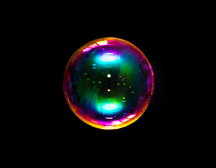 Multicolored soap bubble isolated on a black