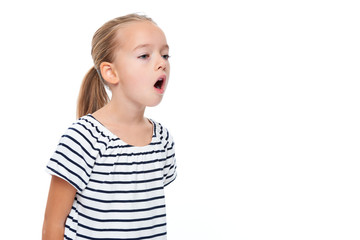 Cute little girl in stripped T-shirt talking. Speech therapy concept over white background.