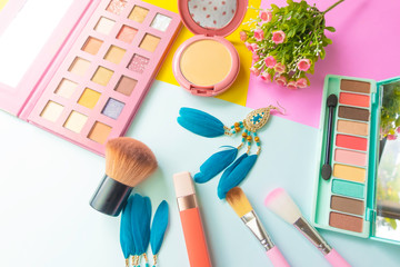 Fototapeta premium Selective focus of powder makeup cushion base foundation and Set of decorative cosmetics for makeup which cosmetic beauty products on pastel colored background,