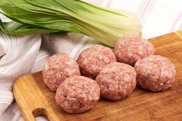 Minced meat meatballs on rustic background