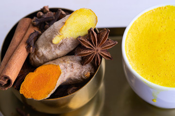 Close up of Ayurvedic beverage Golden Milk Ingredients ginger, turmeric, anise, clove and cinnamon spices.