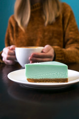 Woman headless and hands with latte.