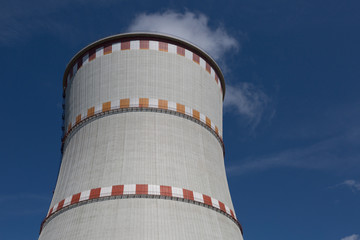 Cooling tower of nuclear power plant against the blue sky