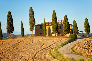 Rural house and cypress avenue, typical landscape of Tuscany, Italy