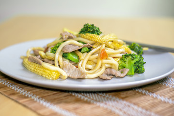 Stir-Fried Udon Noodles with Broccoli, Baby Corn and Carrots.