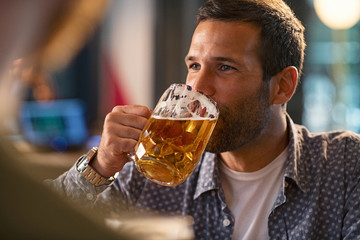 Man drinking a pint of draft beer