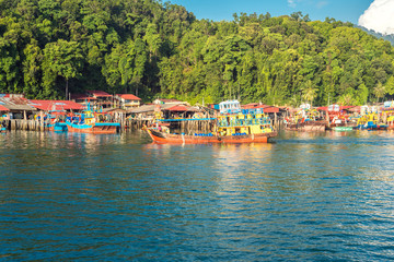 Fototapeta na wymiar Many fishing trawler are moored in front of the island of Pangkor on the west coast of Malaysia in the Malaysian state of Perak 