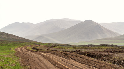 Fototapeta premium Winding dirt road in farm field