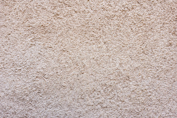 Close-up of a texture fragment of a decorative wall plaster on a building wall