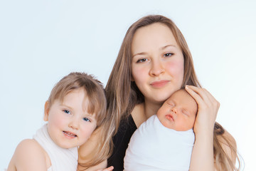 concept of healthy lifestyle, the protection of children, shopping - baby in the arms of the mother. Woman holding a child. Tree girls. Isolated on white background. Copy space. 8 march, mother's day