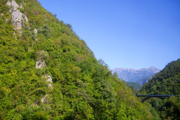 Obraz premium view of green Balkans and bridge high in the mountains