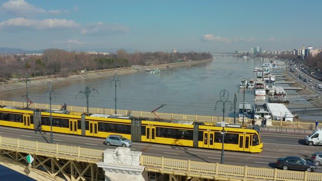Budapest, Hungary - 4K drone following a yellow tram on Margaret Bridge