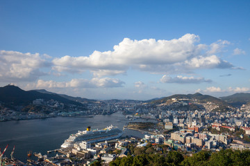Fototapeta na wymiar Nabekanmuri Park Observation Platform city in Japan, High angle view of Nagasaki park. Garden, nature and city view, seaside city in asia with harbor and boat on blue sea, observatory of the bay. 