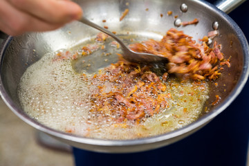 fried crispy bacon in a frying pan