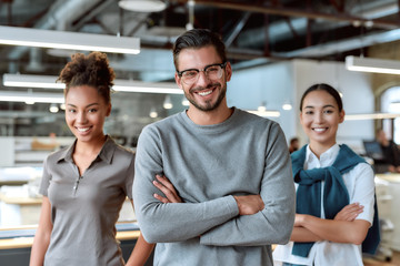 Add ingredient in your success. Young colleagues posing in office
