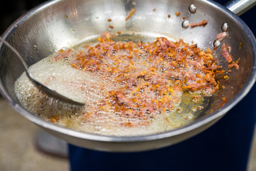 fried crispy bacon in a frying pan