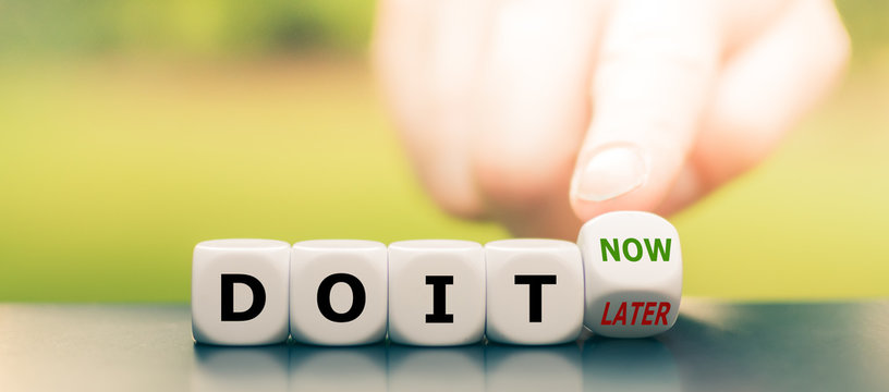 Hand turns dice and changes the expression "do it later" to "do it now".