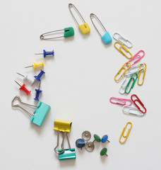 collection of various type of paper clip on white paper background.