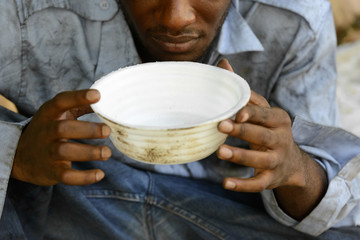 Hands of young homeless African man begging for food