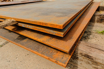 Steel sheets in warehouse. Piles of steel metal in stock