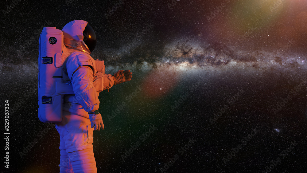 Wall mural astronaut presenting an empty space in front of milky way galaxy