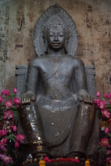 Phra Than Thantharath in temple Na Phra Meru material Carved from green stone Behind the old brown walls