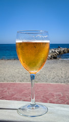 glass of lager on a table in a bar in the beach