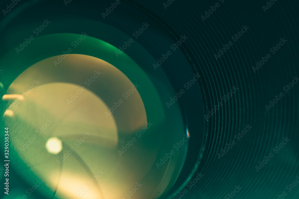 Poster Beautiful camera lens with green  light of glass. Background pattern for design..
