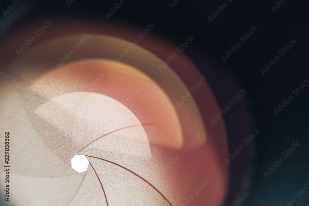 Poster Beautiful camera lens with orange  light of glass. Background pattern for design..